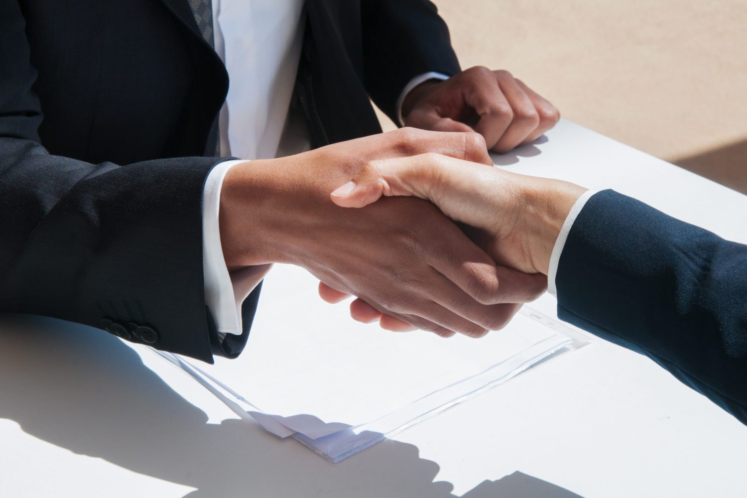 closeup-business-people-shaking-hands-outdoors-scaled.jpg